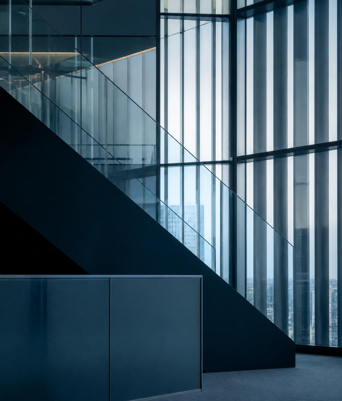 Contemporary office interior with layered glass and structural lines